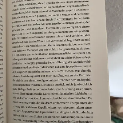A book page photographed at a slight angle, three words underlined in pencil.